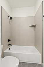 Full bath with toilet and shower / tub combination