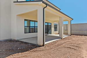 Back of property with a patio area and stucco siding