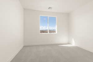 Spare room featuring carpet flooring and a mountain view