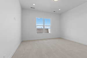 Unfurnished room with light carpet and recessed lighting