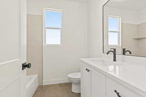 Bathroom featuring vanity and shower / bathtub combination