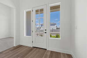 Doorway featuring wood finished floors