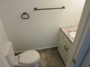 Half bathroom featuring vanity and light tile patterned floors