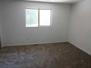 Spare room with dark carpet