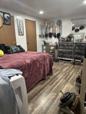 Bedroom with wood finished floors and recessed lighting