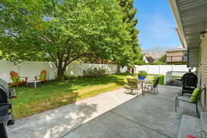 Fenced backyard with a patio and outdoor dining area
