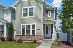 View of front of home featuring a gate and stone siding