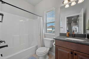 Bathroom with shower / bath combo and vanity