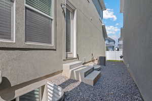 View of property exterior with stucco siding and a cooling unit