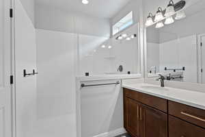 Bathroom featuring vanity and a walk in shower
