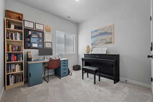 Office with light colored carpet and baseboards
