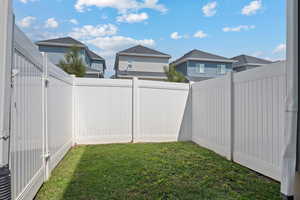 Fenced backyard with a residential view