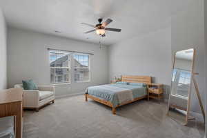 Carpeted bedroom with a ceiling fan and a textured ceiling