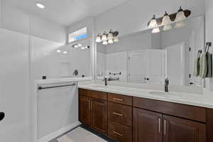 Full bathroom featuring double vanity and walk in shower