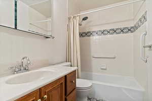 Bathroom featuring shower / tub combo and vanity