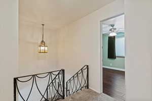 Stairway with carpet flooring and wood finished floors