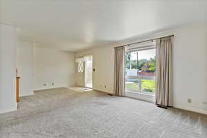 Empty room featuring light colored carpet