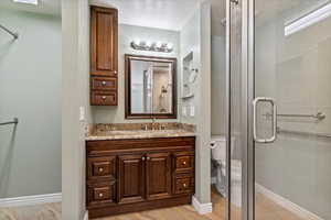 Bathroom featuring a shower stall and vanity