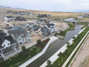 Aerial view of residential area featuring a nearby body of water