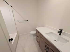 Full bathroom with vanity, shower / tub combination, and light tile patterned floors