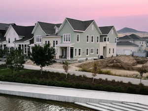 View of front of house featuring a porch and a residential view on the watercourse