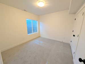 Basement bedroom #4 with carpet and a textured ceiling