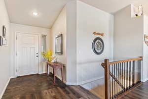 Entrance foyer with dark wood-style floors and recessed lighting