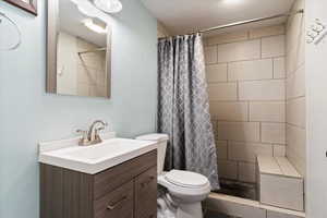 Full bathroom featuring vanity and a shower stall