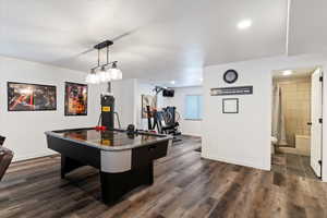 Playroom featuring dark wood-type flooring and recessed lighting