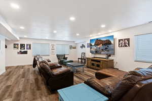 Living area with wood finished floors and recessed lighting
