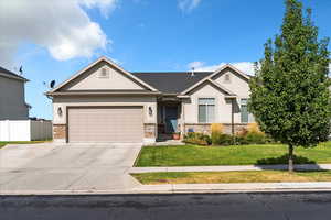 Ranch-style house with stucco siding, concrete driveway, and a garage
