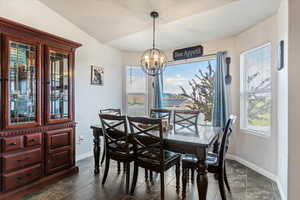 Dining room with baseboards and a chandelier