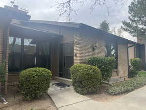 Entrance to property featuring brick siding