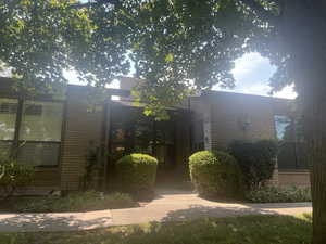 Entrance to property featuring brick siding
