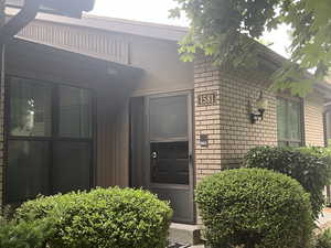 Property entrance featuring brick siding