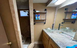 Bathroom with vanity and a tile shower