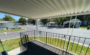 Porch featuring a lawn