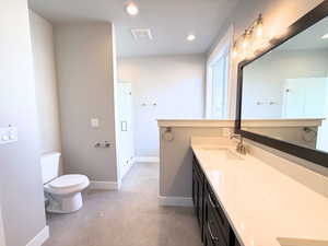 Full bathroom with double vanity, recessed lighting, and a stall shower
