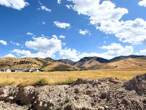 View of mountain backdrop featuring rural landscape