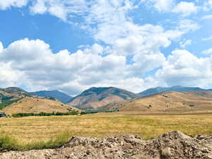 View of mountain backdrop with rural landscape