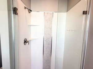 Full bathroom with a shower stall