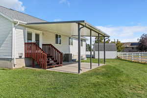 Rear view of property with a patio area, a fenced backyard, and a storage shed