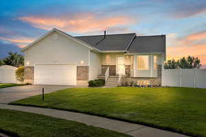 View of front of house with driveway, brick siding, a gate, and a shingled roof