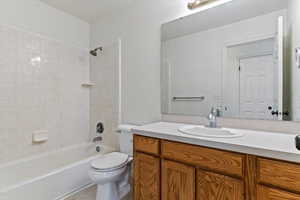 Full bath featuring bathing tub / shower combination, vanity, and light tile patterned floors