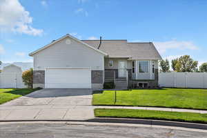 View of front facade with a gate and concrete driveway
