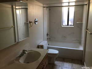 Bathroom with shower / bathtub combination, vanity, inlaid floor details, and light tile patterned floors