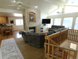 Living room featuring ceiling fan and a brick fireplace
