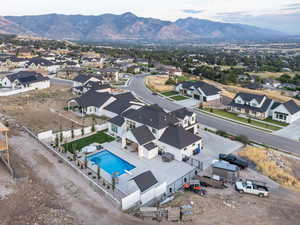 Aerial view of residential area with a mountain backdrop and a pool