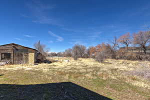 View of yard featuring a view of countryside and an outbuilding