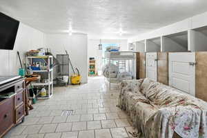 Dog Living area featuring a textured ceiling and light tile patterned floors